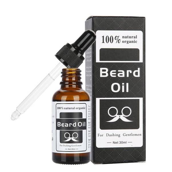 100% natural organic beard oil bottle with a dropper, featuring a wooden background and green plant accents.
