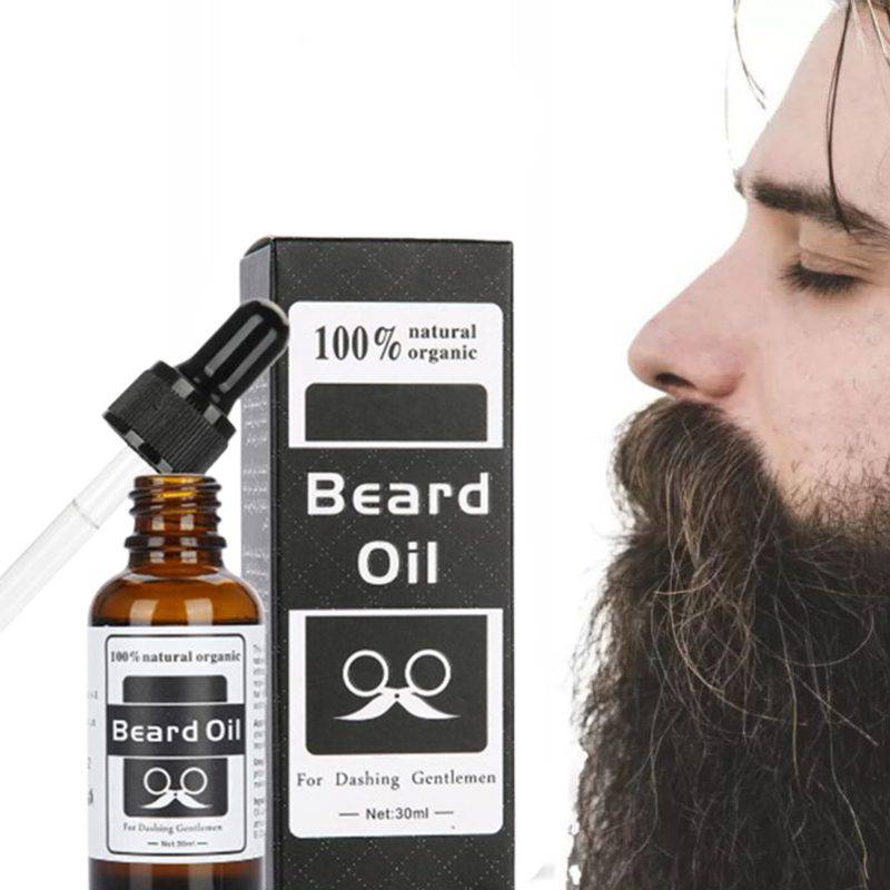 100% Natural Organic Beard Oil bottle with a dropper on a wooden surface, showcasing its rich amber color and label.