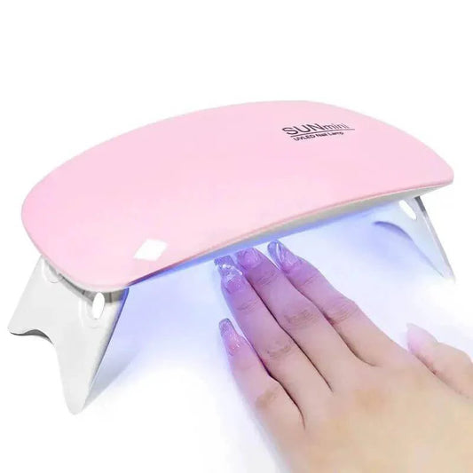 Mini UV LED nail dryer in white, designed for quick drying of gel polish, showcasing a compact and portable design.